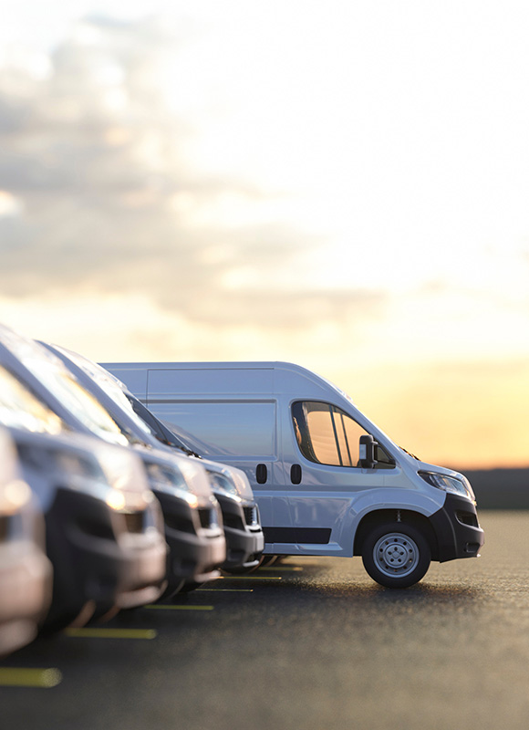 white delivery van parked among several other vans at sunset with 8 new features and designs